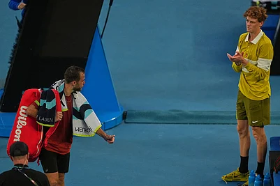 | Photo: AP/Asanka Brendon Ratnayake : Hugo Gaston, left, of France walks from the court after retiring from his first round match against Jannik Sinner, right, of Italy at the Australian Open tennis championship in Melbourne, Australia.