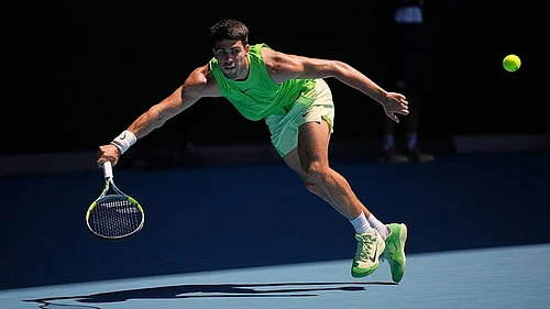 | Photo: AP/Dita Alangkara : Carlos Alcaraz of Spain plays a forehand return to Yannick Hanfmann of Germany during their second round match at the Australian Open tennis championship in Melbourne, Australia.