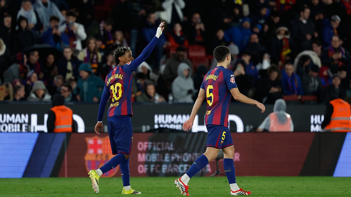 (AP Photo/Joan Monfort) : Barcelona's Lamine Yamal, left, celebrates after scoring his side's third goal during a Spanish La Liga soccer match between Barcelona and Real Oviedo in Barcelona, Spain, Sunday, Jan. 25, 2026.