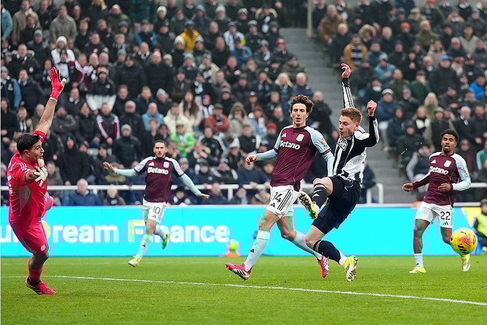 | Photo: Owen Humphreys/PA via AP : Newcastle Uniteds Harvey Barnes, center right, misses the ball during their English Premier League soccer match against Aston Villa in Newcastle upon Tyne, England