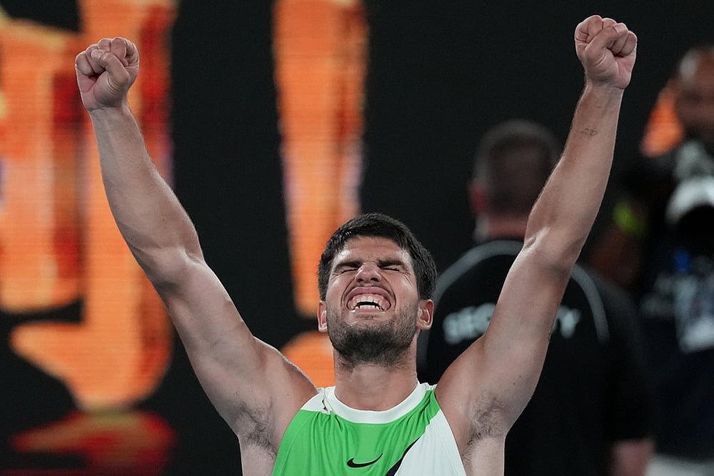 | Photo: AP/Dita Alangkara : Carlos Alcaraz of Spain celebrates after defeating Alex de Minaur of Australia in their quarterfinal match at the Australian Open tennis championship in Melbourne, Australia.