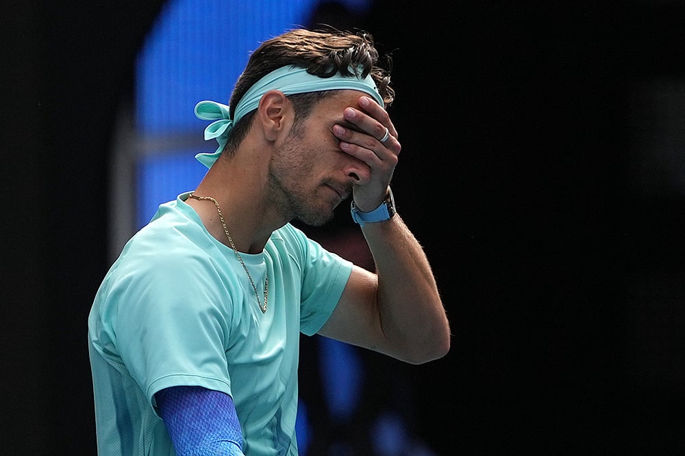 | Photo: AP/Asanka Brendon Ratnayake : Lorenzo Musetti of Italy reacts as he withdraws from his quarterfinal match against Novak Djokovic of Serbia at the Australian Open tennis championship in Melbourne, Australia.