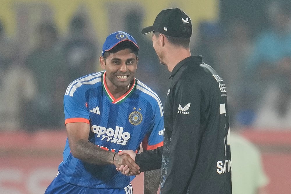 | Photo: AP/Aijaz Rahi : Indias captain Suryakumar Yadav, left, shakes hand with New Zealands captain Mitchel Santner after the toss at the start of the fourth T20 cricket match between India and New Zealand in Visakhapatnam.