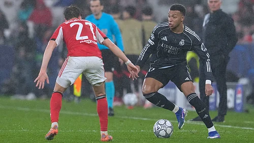 | Photo: AP/Armando Franca : Real Madrids Kylian Mbappe, right, vies for the ball with Benficas Andreas Schjelderup during a Champions League opening phase soccer match between Benfica and Real Madrid, in Lisbon, Wednesday, Jan. 28, 2026.