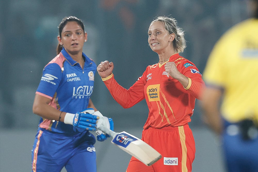 | Photo: BCCI via PTI : Gujarat Giants captain Ashleigh Gardner, right, celebrates after winning a Womens Premier League (WPL) 2026 T20 International cricket match between Gujarat Giants and Mumbai Indians, at BCA Stadium, in Vadodara, Gujarat. Mumbai Indians’ captain Harmanpreet Kaur is also seen. 