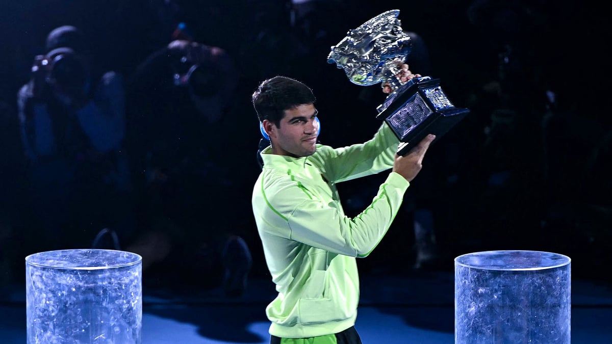Carlos Alcaraz holds the Norman Brookes Challenge Cup aloft.