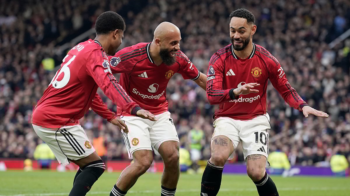 (AP Photo/Dave Thompson) : Manchester United's Matheus Cunha, right, celebrates with Manchester United's Amad Diallo, left, and Manchester United's Bryan Mbeumo after scoring his side's second goal during the English Premier League soccer match between Manchester United and Fulham in Manchester, England, Sunday, Feb. 1, 2026.