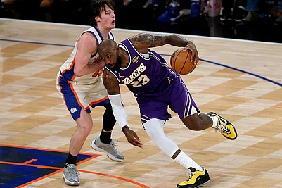 | Photo: AP/John Munson : Los Angeles Lakers forward LeBron James (23) dribbles around New York Knicks guard Tyler Kolek, left, during the first half of an NBA basketball game in New York.