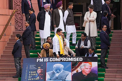 | Photo: PTI/Salman Ali : Congress MP Priyanka Gandhi Vadra with Lok Sabha MPs who were suspended on Tuesday for the remainder of the Budget session for unruly behaviour, as they stage a protest with a poster ‘PM is compromised’, at Parliament premises in New Delhi.
