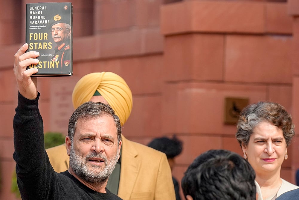 | Photo: PTI/Shahbaz Khan : Leader of Opposition in the Lok Sabha Rahul Gandhi shows a copy of the unpublished memoir of former Army chief M M Naravane during the Budget Session of Parliament, in New Delhi. Congress MP Priyanka Gandhi Vadra also seen. 
