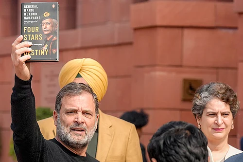 | Photo: PTI/Shahbaz Khan : Leader of Opposition in the Lok Sabha Rahul Gandhi shows a copy of the unpublished memoir of former Army chief M M Naravane during the Budget Session of Parliament, in New Delhi. Congress MP Priyanka Gandhi Vadra also seen.