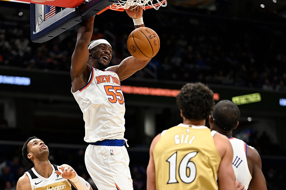 | Photo: AP/John McDonnell : New York Knicks center Ariel Hukporti (55) dunks during the second half of an NBA basketball game against the Washington Wizards in Washington. 