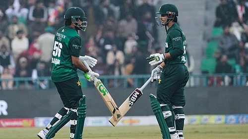 AP : Pakistans Babar Azam, left, and Saim Ayub bat during the third T20I against Australia in Lahore.