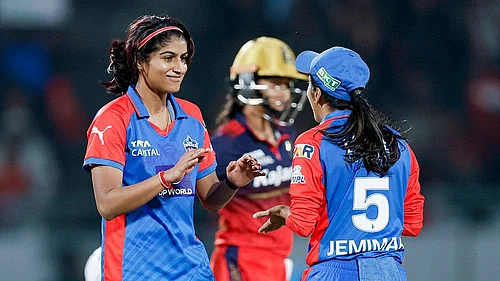 | Photo: BCCI via PTI : Delhi Capitals Nandani Sharma celebrates with captain Jemimah Rodrigues after taking the wicket of Royal Challengers Bengalurus Shreyanka Patil during the Womens Premier League (WPL) 2026 T20 cricket match between Royal Challengers Bengaluru and Delhi Capitals, at BCA Stadium, in Vadodara, Gujarat.