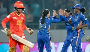 PTI : Mumbai Indians Amelia Kerr, back left, celebrates with captain Harmanpreet Kaur, back centre, and Hayley Matthews, right, after taking the wicket of Gujarat Giants captain Anushka Sharma during a Womens Premier League (WPL) 2026