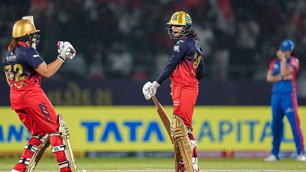 Photo: PTI/Kunal Patil : Royal Challengers Bengalurus Radha Yadav and Nadine de Klerk celebrate after the team won the Womens Premier League (WPL) 2026 final T20 cricket match against Delhi Capitals, at Baroda Cricket Association Stadium, Kotambi in Vadodara, Gujarat.