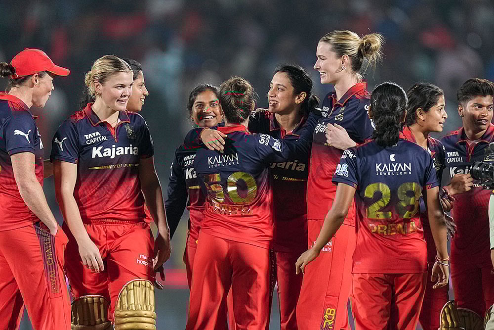 | Photo: PTI/Kunal Patil : Royal Challengers Bengalurus players celebrate after the team won the Womens Premier League (WPL) 2026 final T20 cricket match against Delhi Capitals, at Baroda Cricket Association Stadium, Kotambi in Vadodara, Gujarat.