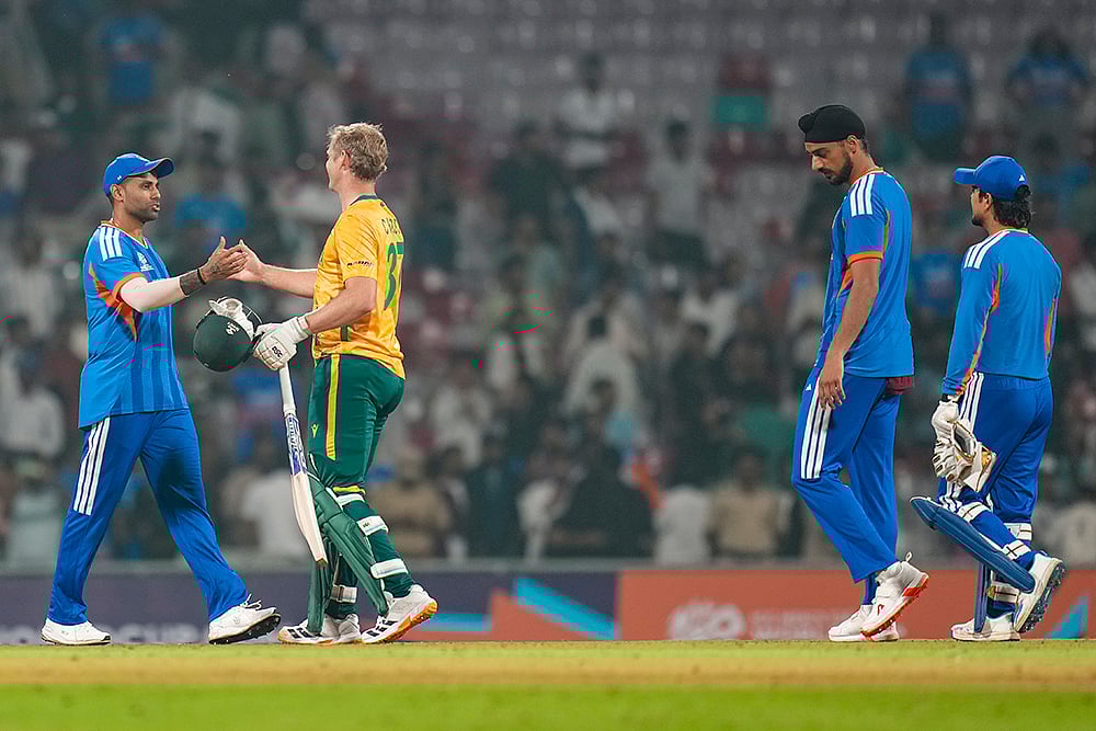 | Photo: PTI/Shashank Parade : Indias captain Suryakumar Yadav and South Africas Corbin Bosch exchange greetings after the formers team won the ICC Mens T20 World Cup warm-up cricket match against South Africa, at the DY Patil Sports Academy, in Navi Mumbai.