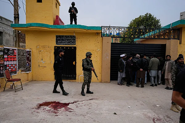 Photo: AP/Anjum Naveed : Pakistani paramilitary and police commandos take positions at the site of a bomb explosion at a Shiite mosque, in Islamabad, Pakistan.