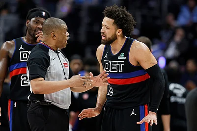 | Photo: AP/Duane Burleson : Detroit Pistons guard Cade Cunningham, right, argues with official Tony Brothers, front left, during the second half of an NBA basketball game against the New York Knicks in Detroit.