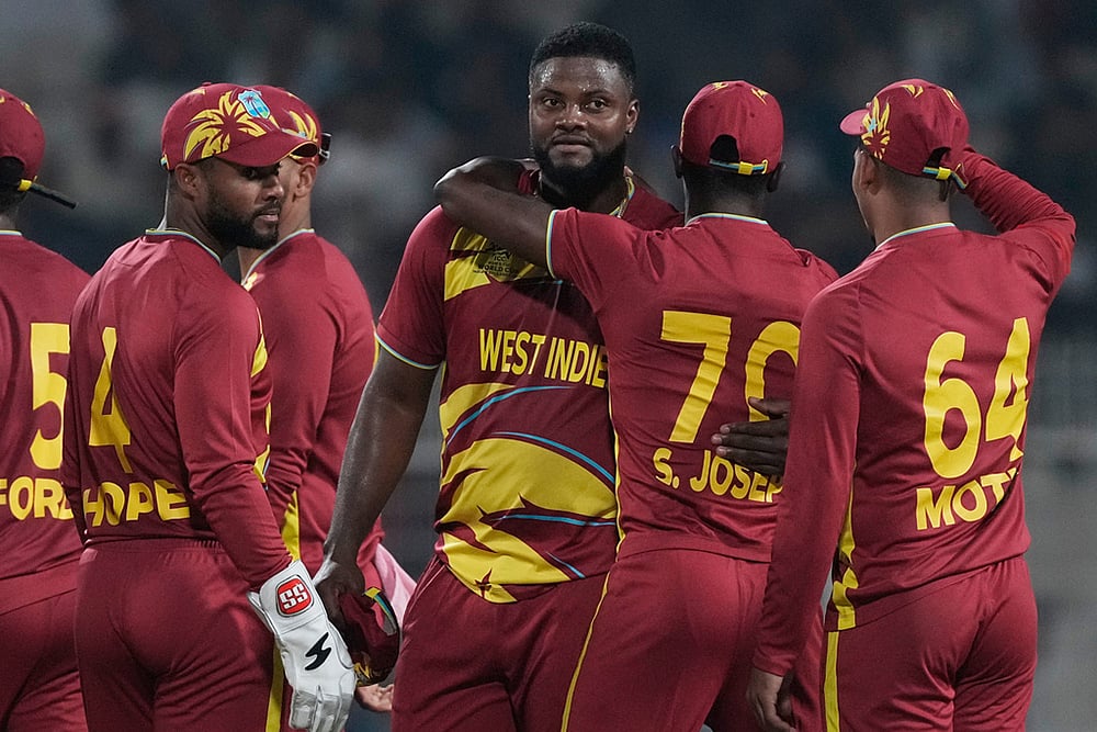 | Photo: AP/Bikas Das : West Indies Romario Shepherd, third from right, celebrates with teammates after taking five-wicket in the match during the T20 World Cup cricket match between Scotland and West Indies in Kolkata.