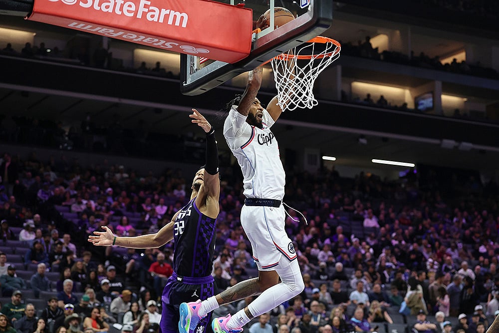 | Photo: AP/Sara Nevis : Los Angeles Clippers forward Derrick Jones Jr., right, makes an alley-oop dunk with Sacramento Kings center Dylan Cardwell defending during the second half of an NBA basketball game in Sacramento, California. 