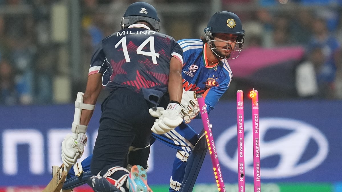 (AP Photo/Rafiq Maqbool) : Indias Ishan Kishan, right, unsuccessfully attempts for the run out wicket of United States Milind Kumar, left, during the T20 World Cup cricket match between India and the United States in Mumbai, India, Saturday, Feb. 7, 2026