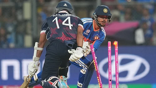 (AP Photo/Rafiq Maqbool) : Indias Ishan Kishan, right, unsuccessfully attempts for the run out wicket of United States Milind Kumar, left, during the T20 World Cup cricket match between India and the United States in Mumbai, India, Saturday, Feb. 7, 2026
