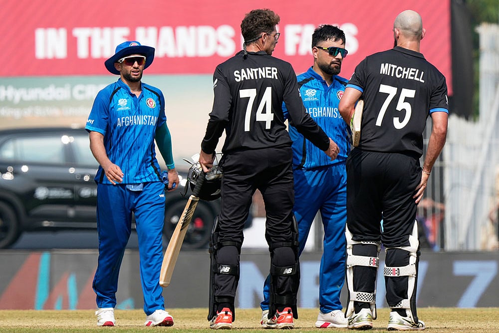 | Photo: AP/Mahesh Kumar A. : Afghanistans captain Rashid Khan, center, greets New Zealands Daryl Mitchell, right, and Mitchel Santner after New Zealand won their T20 World Cup cricket match against Afghanistan in Chennai, India.