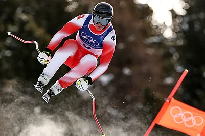 | Photo: AP/Gabriele Facciotti : Switzerlands Franjo von Allmen speeds down the course during an alpine ski, mens downhill race, at the 2026 Winter Olympics, in Bormio, Italy.