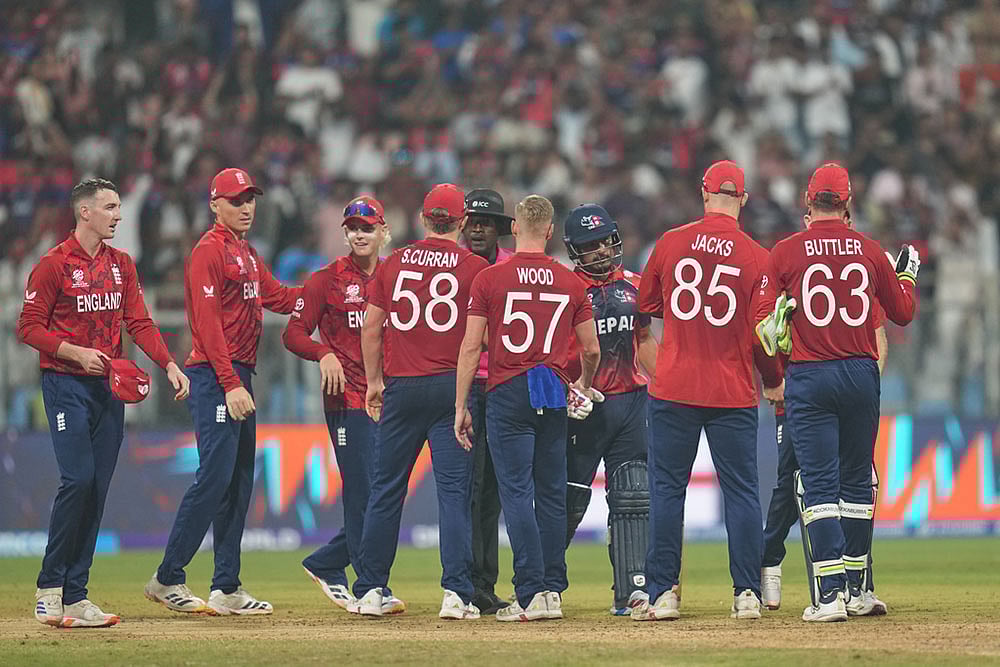 Photo: AP/Rafiq Maqbool : England players celebrate after wining against Nepal during the T20 World Cup cricket match in Mumbai, India.