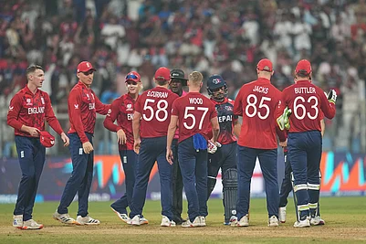 Photo: AP/Rafiq Maqbool : England players celebrate after wining against Nepal during the T20 World Cup cricket match in Mumbai, India.