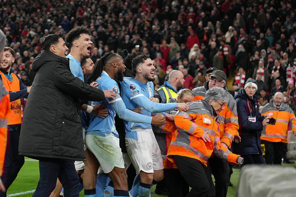 | Photo: AP/Jon Super : Manchester City players celebrate after the English Premier League soccer match between Liverpool and Manchester City in Liverpool, England.