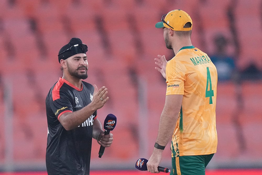 | Photo: AP/Ajit Solanki : Canadas captain Dilpreet Bajwa, left, shake hands with South Africas captain Aiden Markram after the toss of the T20 World Cup cricket match between Canada and South Africa in Ahmedabad.