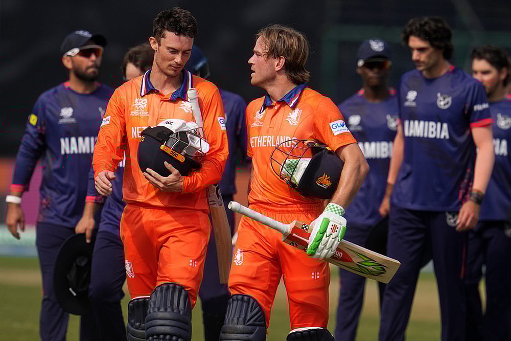 | Photo: AP/Manish Swarup : Netherlands captain Scott Edwards, left and Netherlands Bas de Leede walks out of the field after their win over Namibia during the T20 World Cup cricket match between Namibia and Netherlands in New Delhi.
