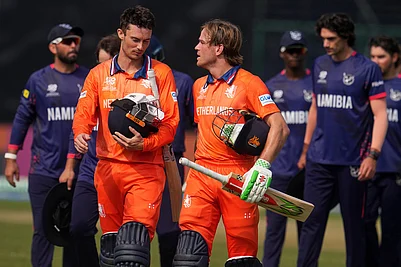 | Photo: AP/Manish Swarup : Netherlands captain Scott Edwards, left and Netherlands Bas de Leede walks out of the field after their win over Namibia during the T20 World Cup cricket match between Namibia and Netherlands in New Delhi.