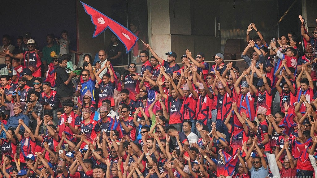 AP : Nepal cricket teams fans cheer for them during Nepals T20 World Cup match against England in Mumbai.