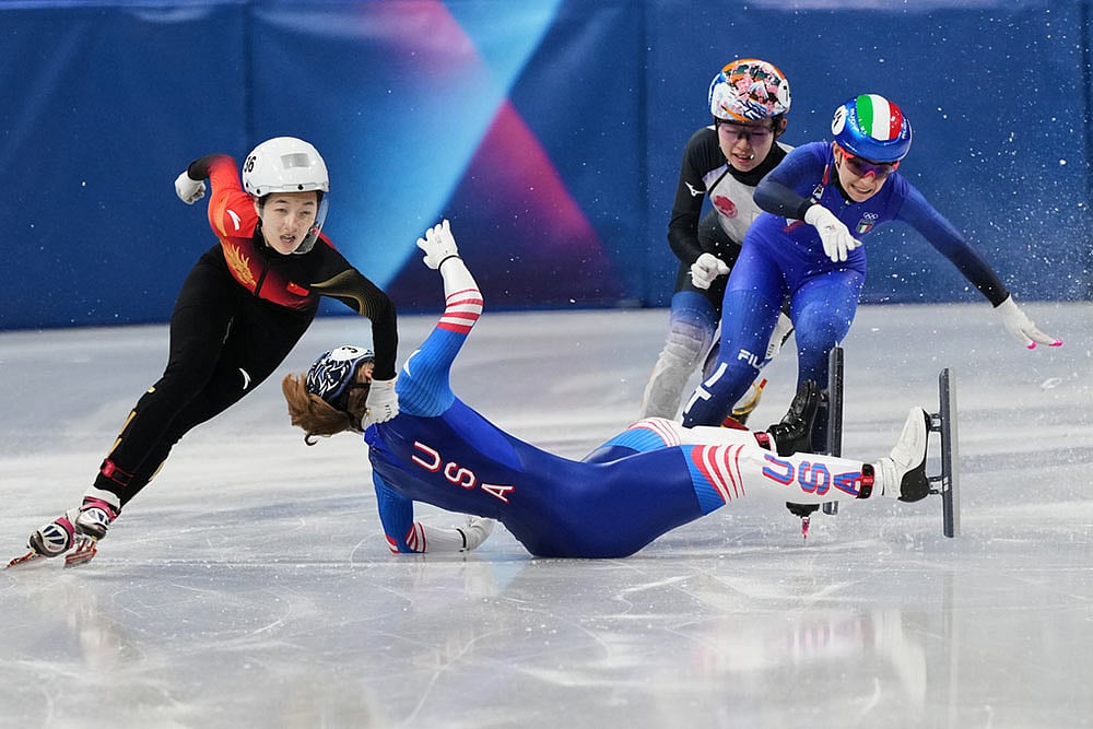 | Photo: AP/Francisco Seco : Corinne Stoddard of the United States wipes out as Xinran Wang of the Peoples Republic of China moves past to win while competing in the womens 500 meter short track speed skating at the 2026 Winter Olympics, in Milan, Italy.