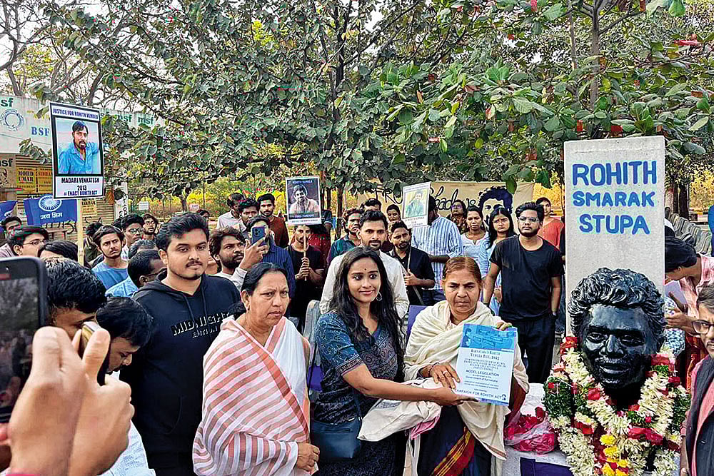 | Photo: Special arrangement : In Memory: Rohith Vemula’s mother standing next to his bust at Velivada, his memorial site on the HCU campus