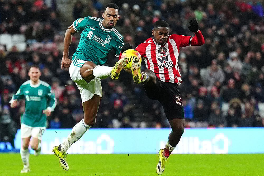 | Photo: Owen Humphreys/PA via AP : Liverpools Ryan Gravenberch, left, and Sunderlands Noah Sadiki battle for the ball during the English Premier League soccer match, in Sunderland, England.