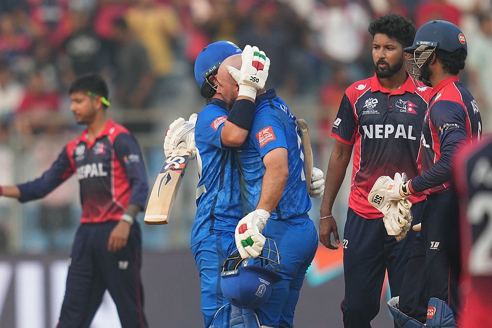 Photo: AP/Rafiq Maqbool : Italys Justin Mosca, left, Anthony Mosca celebrates after won the T20 World Cup cricket match against the Nepal in Mumbai, India.