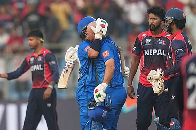 Photo: AP/Rafiq Maqbool : Italys Justin Mosca, left, Anthony Mosca celebrates after won the T20 World Cup cricket match against the Nepal in Mumbai, India.