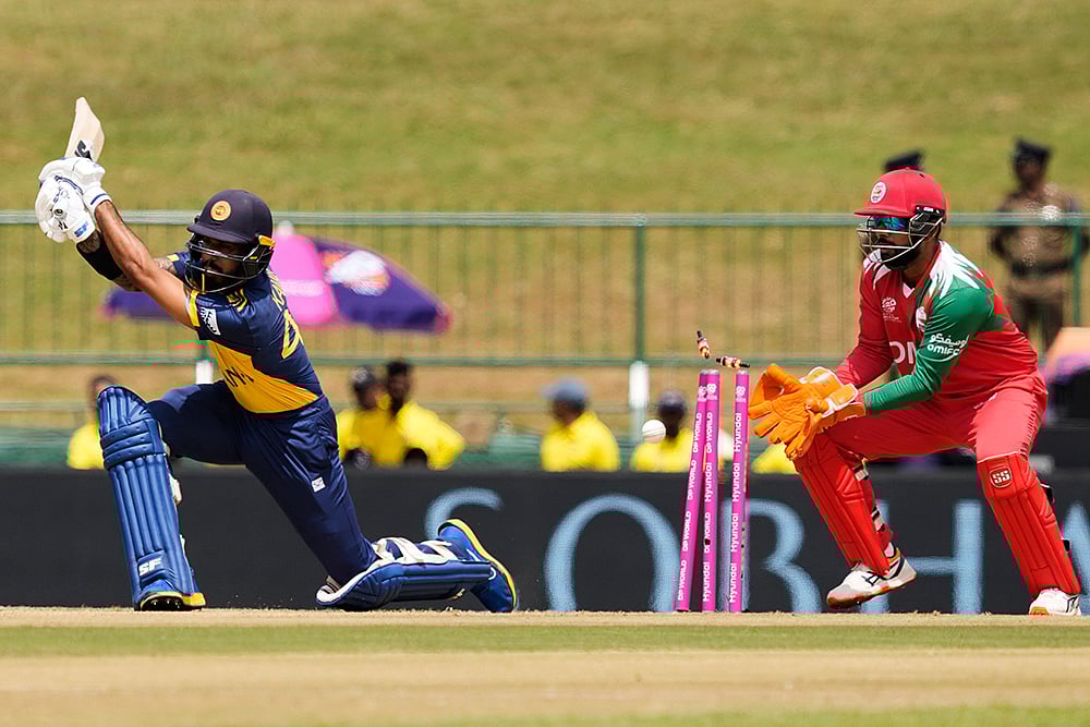 | Photo: AP/Eranga Jayawardena : Sri Lankas Kamil Mishara bowled out by Omans Jay Odedra during the T20 World Cup cricket match between Oman and Sri Lanka in Pallekele, Sri Lanka.