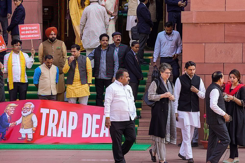 | Photo: PTI/Salman Ali : Congress MP Priyanka Gandhi Vadra, suspended MPs Hibi Eden, Dean Kuriakose, Prashant Padole, Manickam Tagore and other opposition MPs stage a protest over the India-US interim trade deal, accusing the government of surrendering Indian interests, during the Budget session of Parliament, in New Delhi.