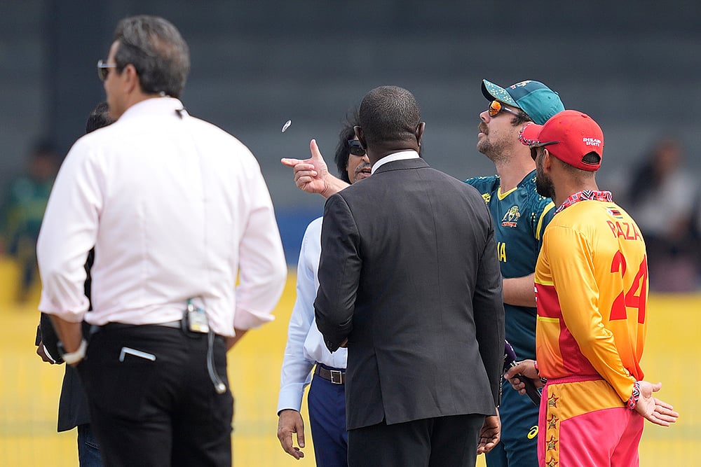 | Photo: AP/Eranga Jayawardena : Australias captain Travis Head, second right, toss the coin as Zimbabwes captain Sikandar Raza, right, watch it before the starts of the T20 World Cup cricket match between Australia and Zimbabwe in Colombo, Sri Lanka.
