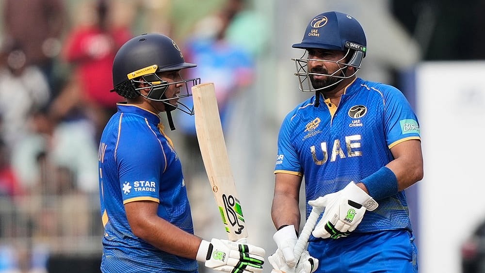 Photo: AP/Mahesh Kumar A. : United Arab Emirates Alishan Sharafu, left, celebrates as United Arab Emirates captain Muhammad Waseem looks on his fifty runs during the T20 World Cup cricket match between New Zealand and United Arab Emirates in Chennai.