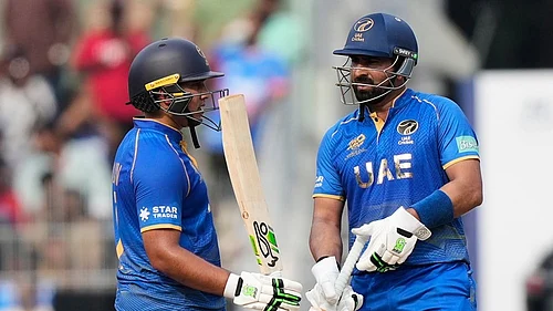 Photo: AP/Mahesh Kumar A. : United Arab Emirates Alishan Sharafu, left, celebrates as United Arab Emirates captain Muhammad Waseem looks on his fifty runs during the T20 World Cup cricket match between New Zealand and United Arab Emirates in Chennai.