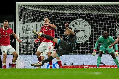 | Photo: Martin Rickett/PA via AP : Ipswich Towns Jacob Greaves, front, has a shot at goal blocked by Wrexhams George Dobson (15) during an English FA Cup fourth round soccer in Wrexham, Wales.