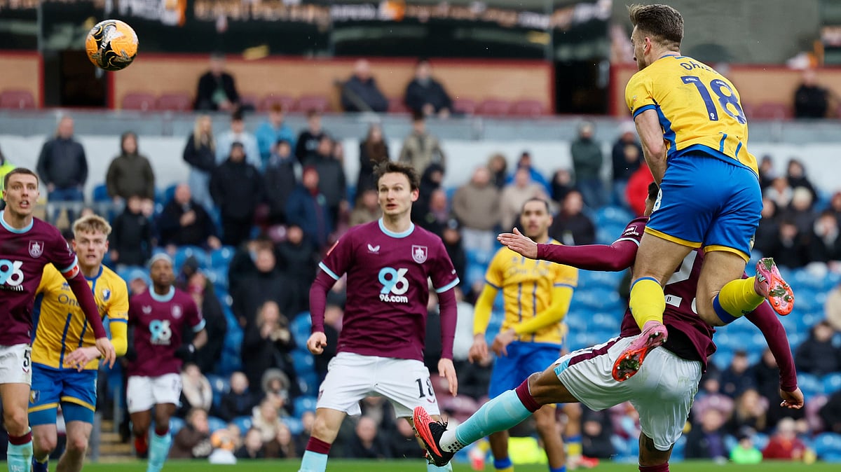 | Photo: PA/Richard Sellers via AP : Mansfield Town's Rhys Oates, top, scores during the English FA Cup fourth round soccer match between Burnley and Mansfield Town in Burnley, England, Saturday Feb. 14, 2026.