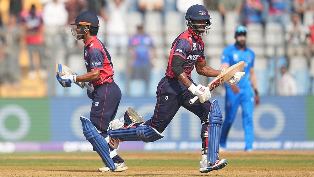Photo: AP/Rafiq Maqbool : Nepals Aasif Sheikh and Nepals captain Rohit Paudel run between the wickets as they bat during the T20 World Cup cricket match between Italy and Nepal in Mumbai, India.